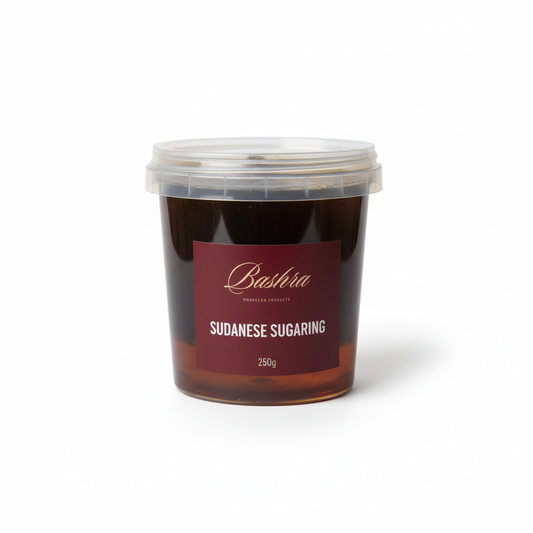 Container of Sudanese sugaring with a red label on a white background
