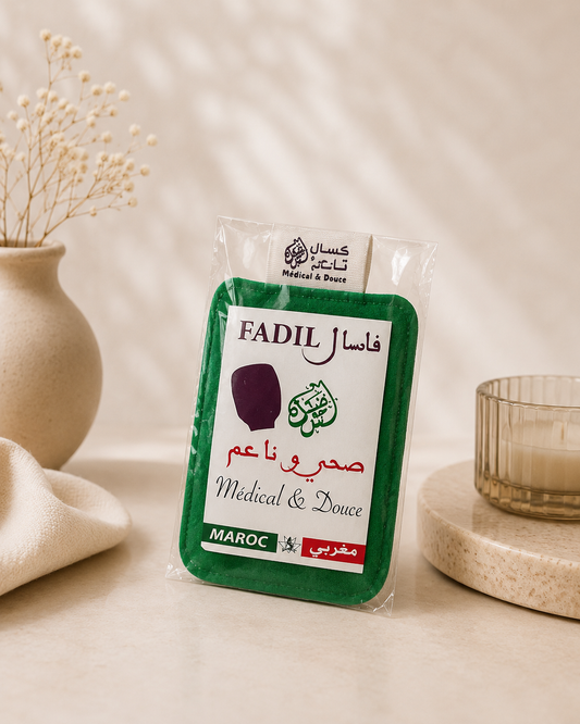 Authentic Moroccan green Kessa exfoliating glove in retail packaging, displayed on a neutral spa-inspired background for traditional Hammam body exfoliation.