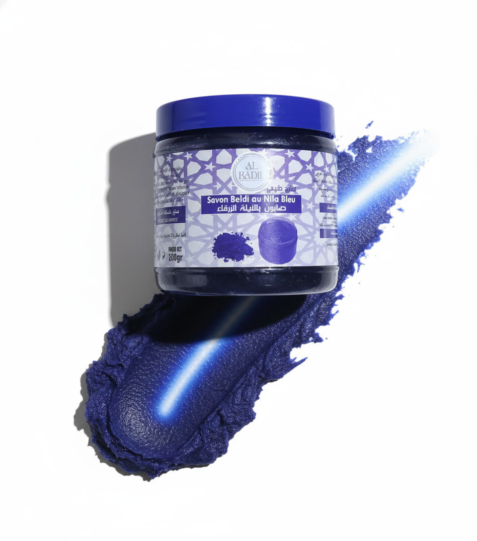 Moroccan Black Soap with Blue Nila Powder. Dark blue hydrating and exfoliating body mask in a round jar for skin purification.