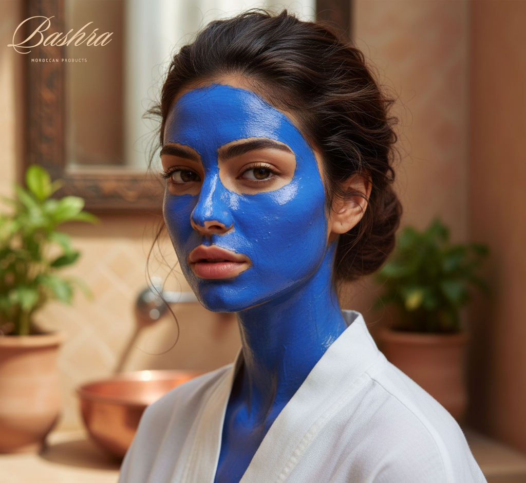A model with spotless, clear skin wearing a bright blue Nila mask, showcasing a luxurious beauty treatment.