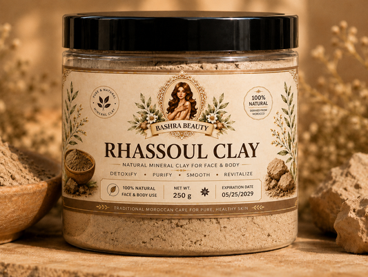 Bashra Beauty Rhassoul Clay 250g jar made from 100% natural Moroccan mineral clay for face and body care, displayed with authentic clay in a warm Moroccan-inspired setting.
