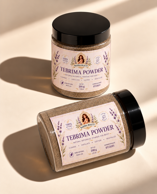 Two Bashra Beauty Tebrima Powder jars, one upright and one lying diagonally, on a warm cream surface with natural sunlight and shadows.