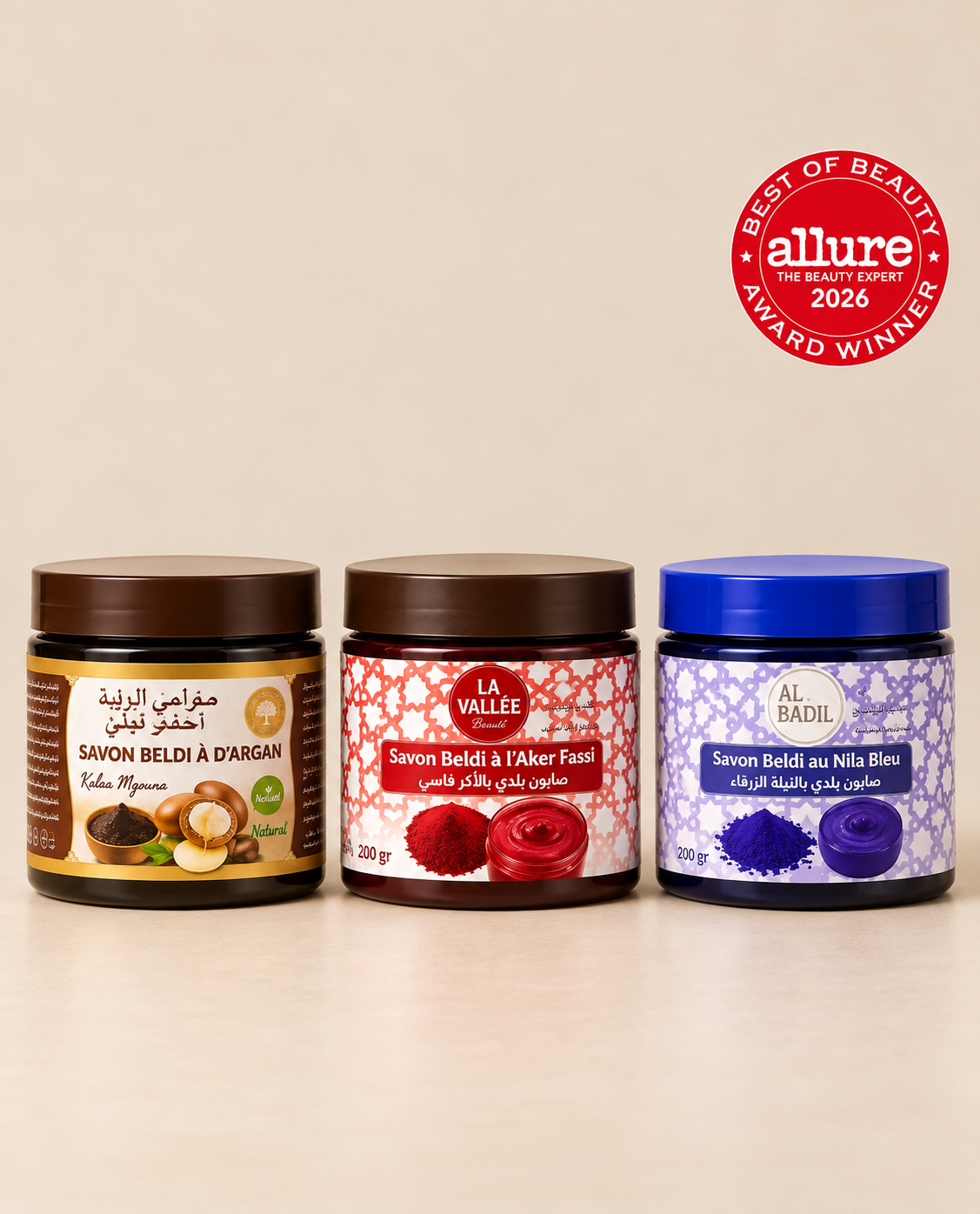 Three Moroccan beldi soaps featuring argan oil, Aker Fassi, and Nila Bleu, displayed side by side against a beige background.